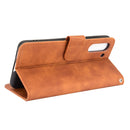 For Samsung Galaxy S21 FE Solid Color Skin Feel Magnetic Buckle Horizontal Flip Calf Texture PU Leather Case with Holder & Card Slots & Wallet(Brown)